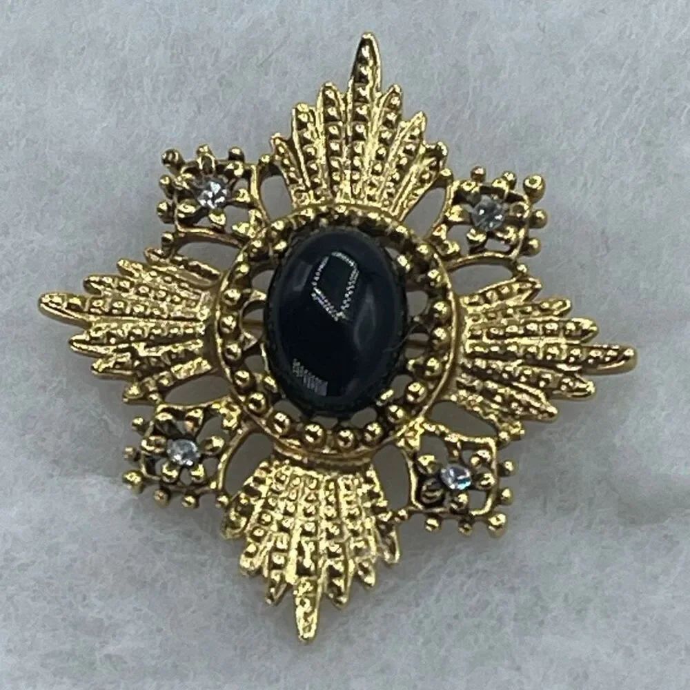 Vintage black cabochon Maltese Cross or starbust ornate scrollwork.